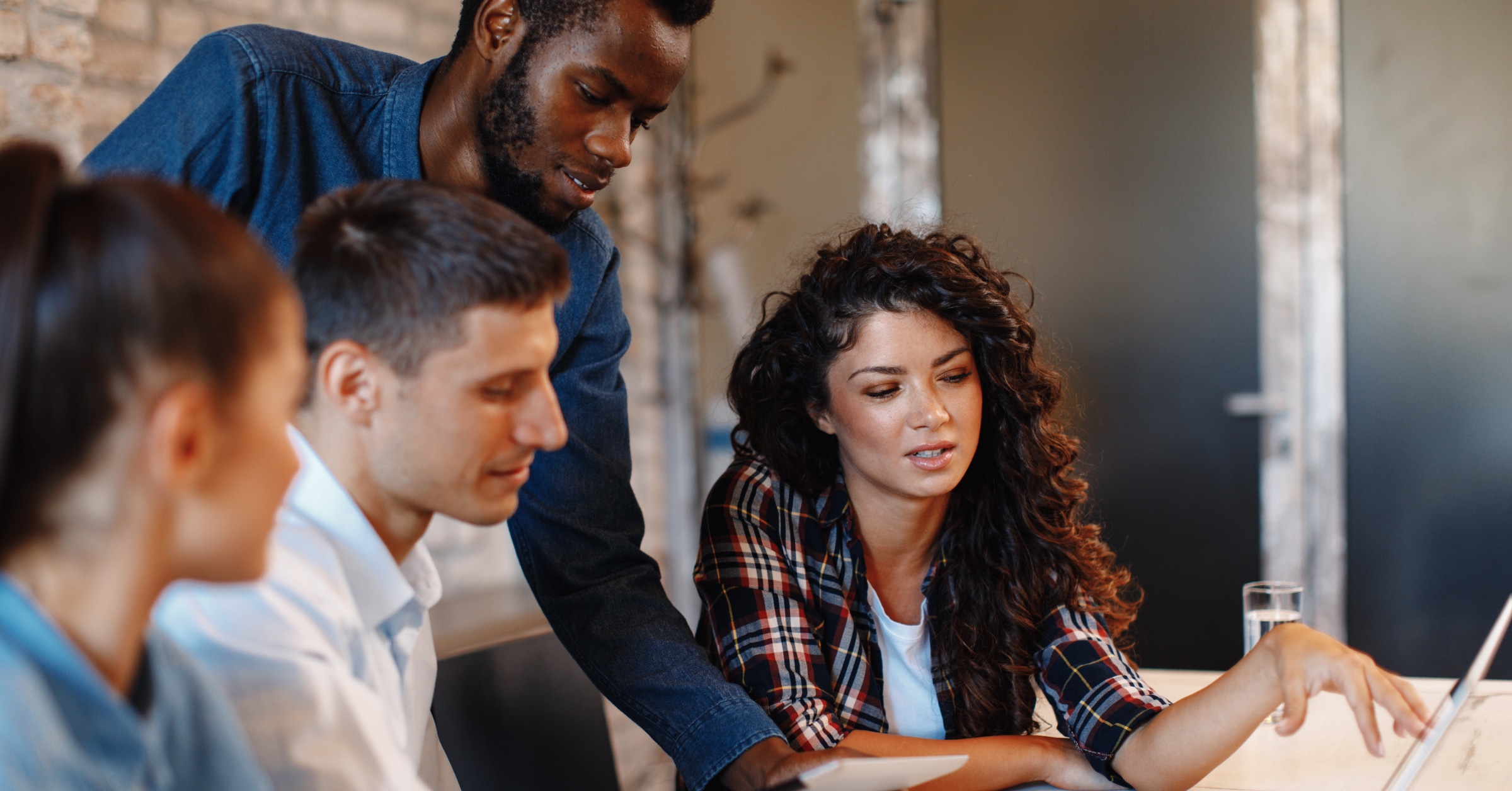 Male and female colleagues discussing at a table.