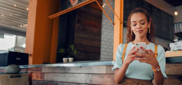 Woman typing on phone