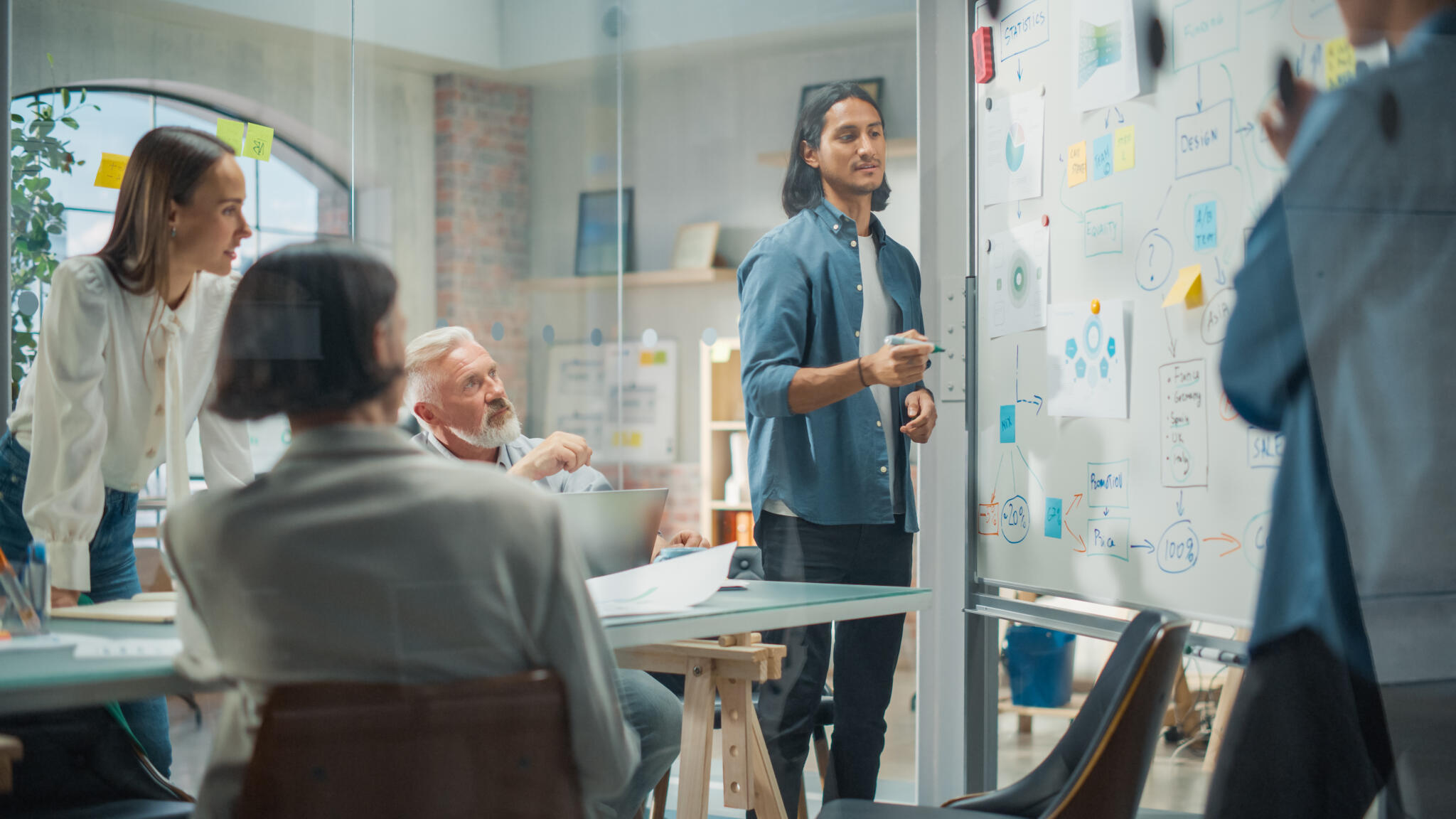 Multiethnic Business Team Discussing Strategy in a Meeting Room